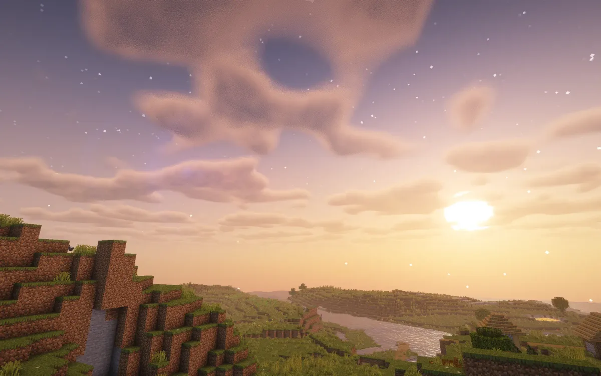 Skull-shaped cloud over a river valley at sunset