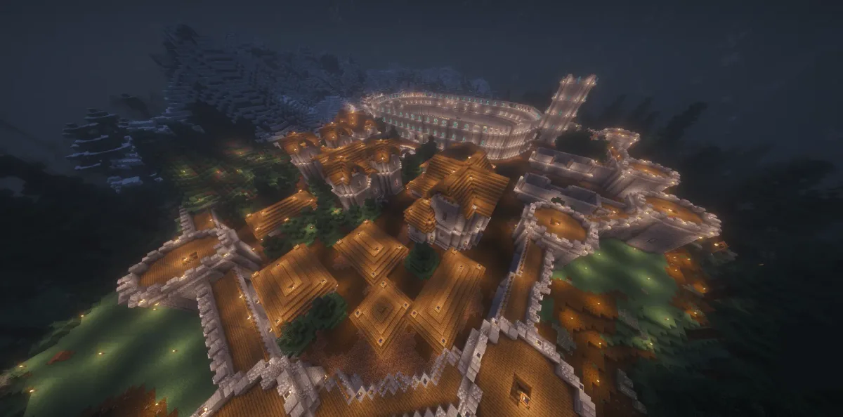 Night aerial of a lantern-lit walled town with a colosseum