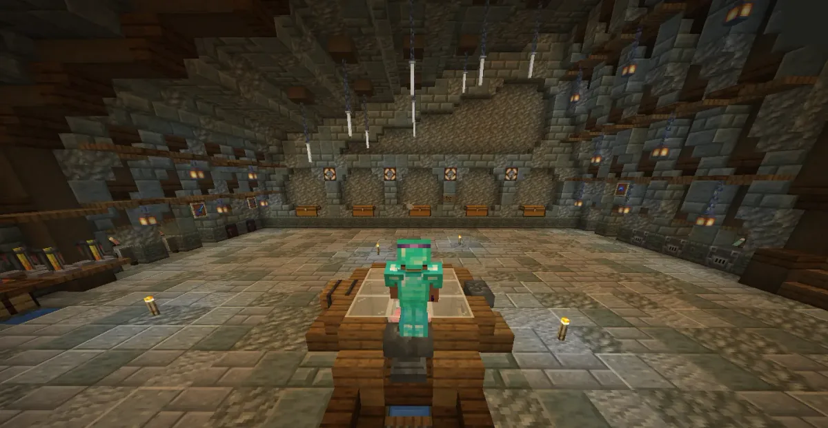 Player in diamond armour seated on a wooden chair in a large stone hall